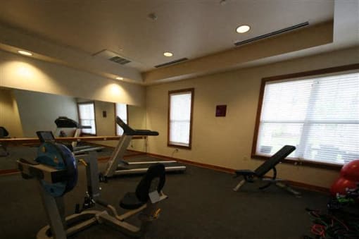 Fitness center with workout machines-Senior Living at Cambridge Heights Apartments, St. Louis, MO