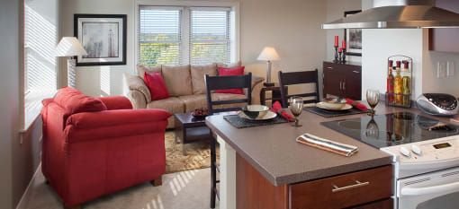 a living room with a kitchen and a couch at Valentine Apartments