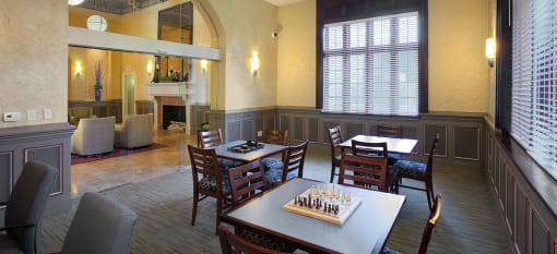 Valentine Apartments clubhouse with tables and chairs and a chess board