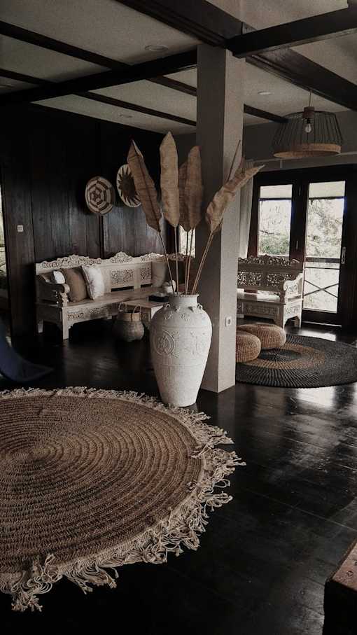 a large white vase sitting on top of a rug
