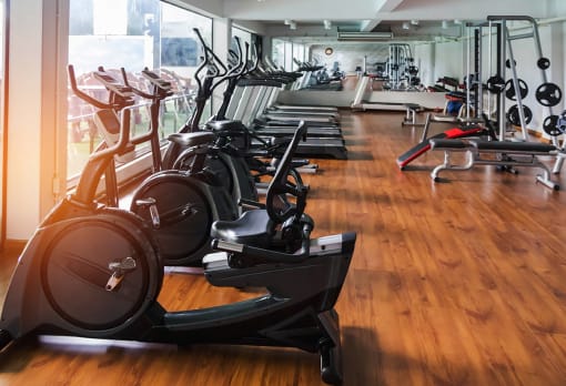 Rows of stationary bike and exercise equipment for bodybuilding in gym modern fitness center room