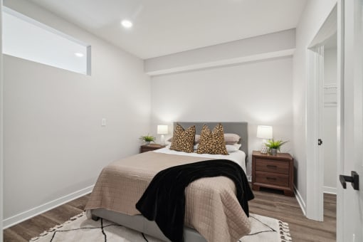 a bedroom with white walls and a bed with pillows