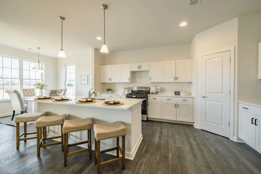 Kitchen and dining room with island and recess lighting