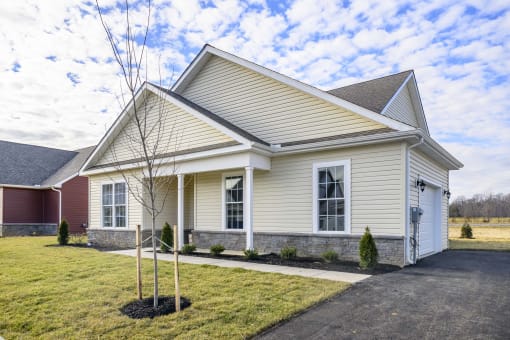 Exterior of pale yellow single story cottage