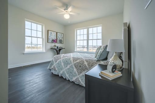 2nd bedroom with windows and fan
