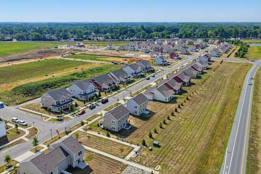 A suburban neighborhood with houses and a road.