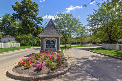 the welcome sign at the end of a street in a neighborhood with trees at Brookstone Village, Cincinnati
