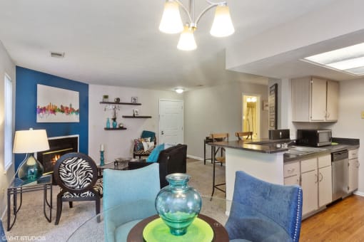 a living room and kitchen with a dining room table and chairs at Brookstone Village, Cincinnati