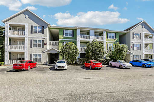Three story apartment buildings with balconies and parking at The Arbor Walk Apartments, Florida, 33617