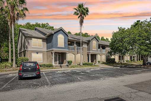A car is parked in a parking lot in front of a building  at The Parkway at Hunters Creek, Orlando, 32837