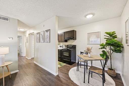 A kitchen with a table and chairs in the middle of the room. at Sarasota South Apartments, Florida, 34207