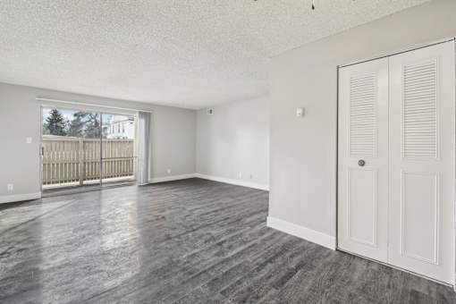 A room with a white door and a window with a view of a fence and a building outside at Spyglass Creek, Denver, 80224