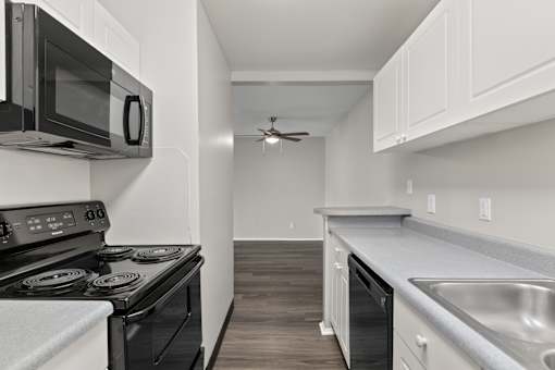 Kitchen with white cabinets and a black stove top oven at Creve Coeur, Creve Coeur, MO