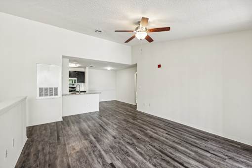 A room with a ceiling fan and wooden flooring at The Parkway at Hunters Creek, Orlando, 32837