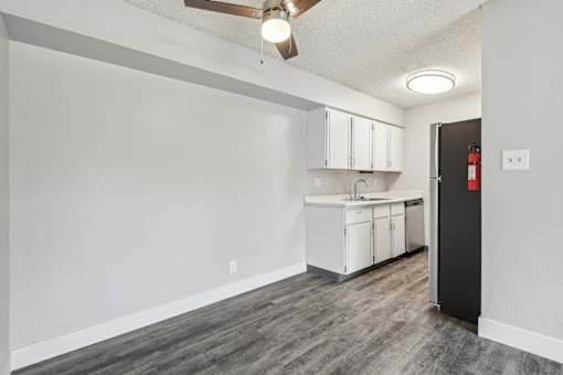 A kitchen area with a sink, cabinets, and a ceiling fan at Spyglass Creek, Denver, 80224