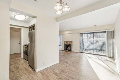 A modern kitchen with a refrigerator, oven, and a fireplace in the living room. at Cliffs at Canyon Ridge, Utah, 84401