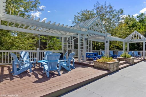 a patio with blue chairs and a white pavilion at Brookstone Village, Cincinnati