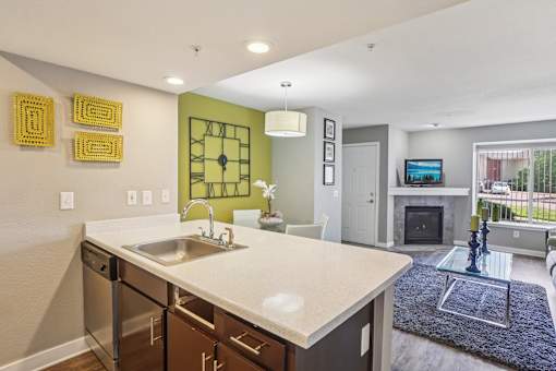A kitchen with a green clock on the wall.