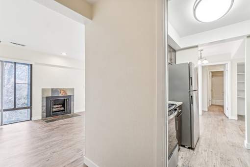 A modern kitchen with a fireplace and a refrigerator. at Cliffs at Canyon Ridge, Utah, 84401