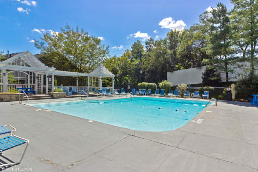 a resort style pool with blue chairs around it and a white gazebo at Brookstone Village, Cincinnati