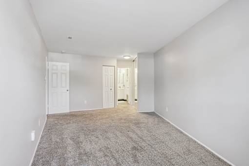 A spacious room with carpeted floor and white walls. at Millennium at Creve Coeur, Missouri