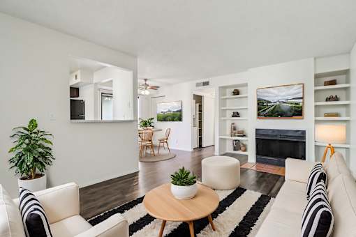 A living room with a fireplace and a couch at Del Coronado Apartment , Mesa, Arizona