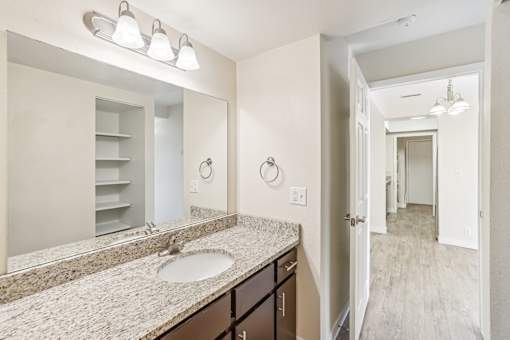 A bathroom with a sink, mirror, and lighting fixtures. at Cliffs at Canyon Ridge, Utah, 84401
