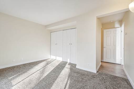A room with a carpeted floor and a white door. at Cliffs at Canyon Ridge, Utah, 84401