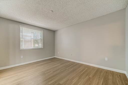 Bedroom with window and wood style flooring at Pembroke Pines Landings, Pembroke Pines, FL, 33025
