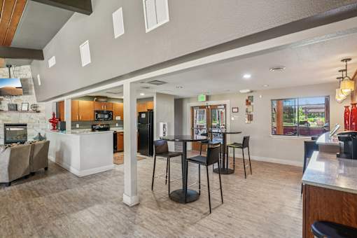 A modern cafe with a white counter and black chairs. at University Village Apartments, Colorado Springs, CO, 80918