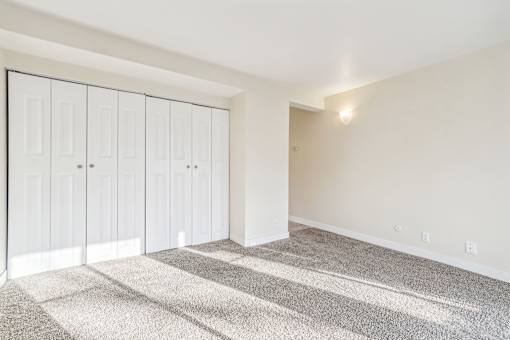 A room with a carpeted floor and a white wall with a row of cupboards. at Cliffs at Canyon Ridge, Utah, 84401