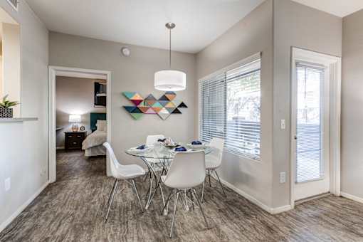 A dining room with a white table and chairs at Sweetwater At Metro North Apartments, Phoenix, AZ
