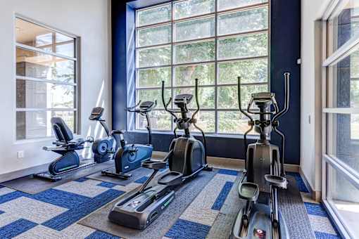 A room with a row of exercise bikes at Sweetwater At Metro North Apartments, Phoenix, AZ 85029