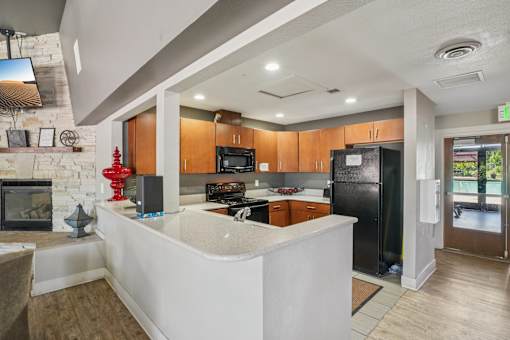 A modern kitchen with a white island and wooden cabinets. at University Village Apartments, Colorado