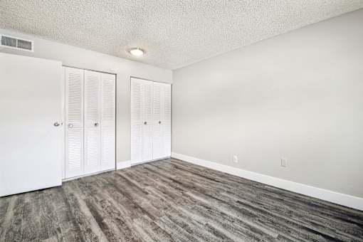 A room with wood flooring and white walls at Spyglass Creek, Denver, 80224