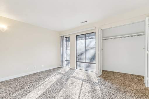 A room with a carpeted floor and sliding glass doors. at Cliffs at Canyon Ridge, Utah, 84401