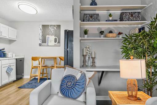 A living room with a white couch and a wooden coffee table.at Lofts of Wilmington, North Carolina