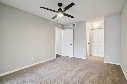 A room with a ceiling fan and carpeted floor. at Lakeside Glen Apartments, Florida, 32904