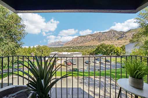A balcony view of a parking lot and mountains at Cliffs at Canyon Ridge, Ogden, UT, 84401