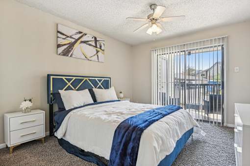 a bedroom with a bed and a ceiling fan at The Glen at Highpoint, Dallas, 75243