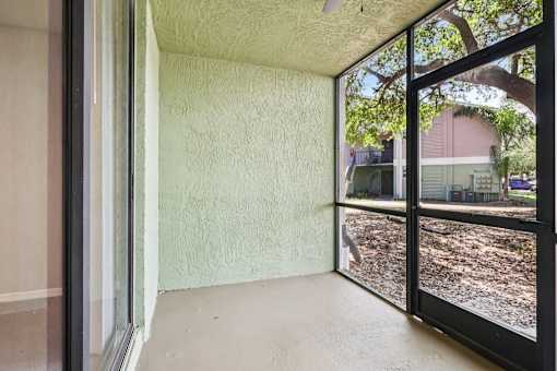 A room with a sliding glass door leading to a backyard. at Lakeside Glen Apartments, Melbourne, FL