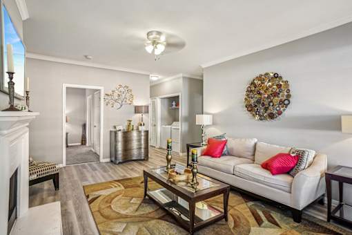 A living room with a white couch and a coffee table. at Bridford Lake Apartments, Greensboro, North Carolina
