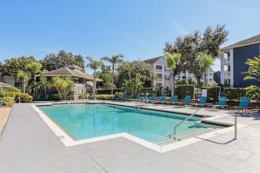 Resort style swimming pool with lounge chairs at The Arbor Walk Apartments, Florida, 33617