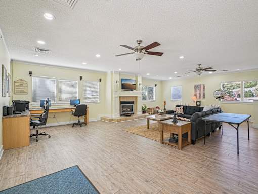 A spacious living room with a fireplace and a television. at Cedar Springs Apartments, Raleigh, NC