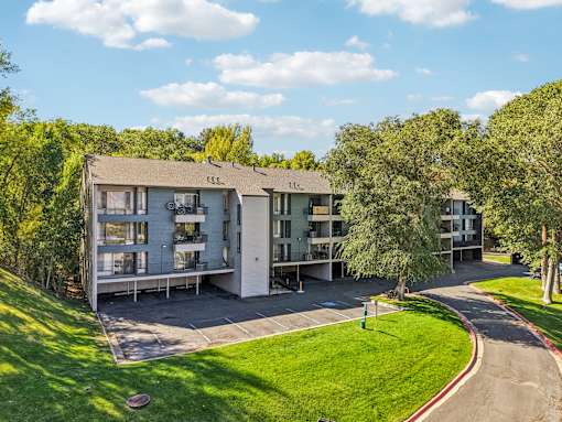 Apartment complex with a green lawn in front at Cliffs at Canyon Ridge, Ogden, UT, 84401