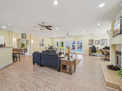 A spacious living room with a ceiling fan and a couch. at Cedar Springs Apartments, North Carolina