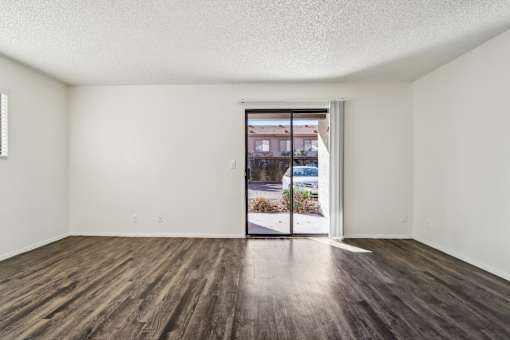 A room with a sliding glass door leading to a street at Del Coronado Apartment , Mesa