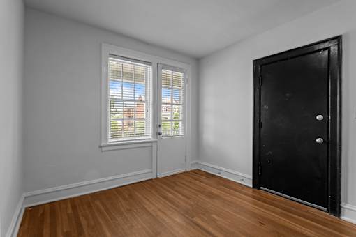 A room with a black door and a window with blinds.at The Collection of Historic Richmond, Richmond Virginia