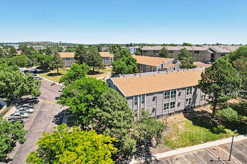 A large building with a parking lot in front of it.