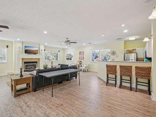A living room with a fireplace and a dining table. at Cedar Springs Apartments, North Carolina